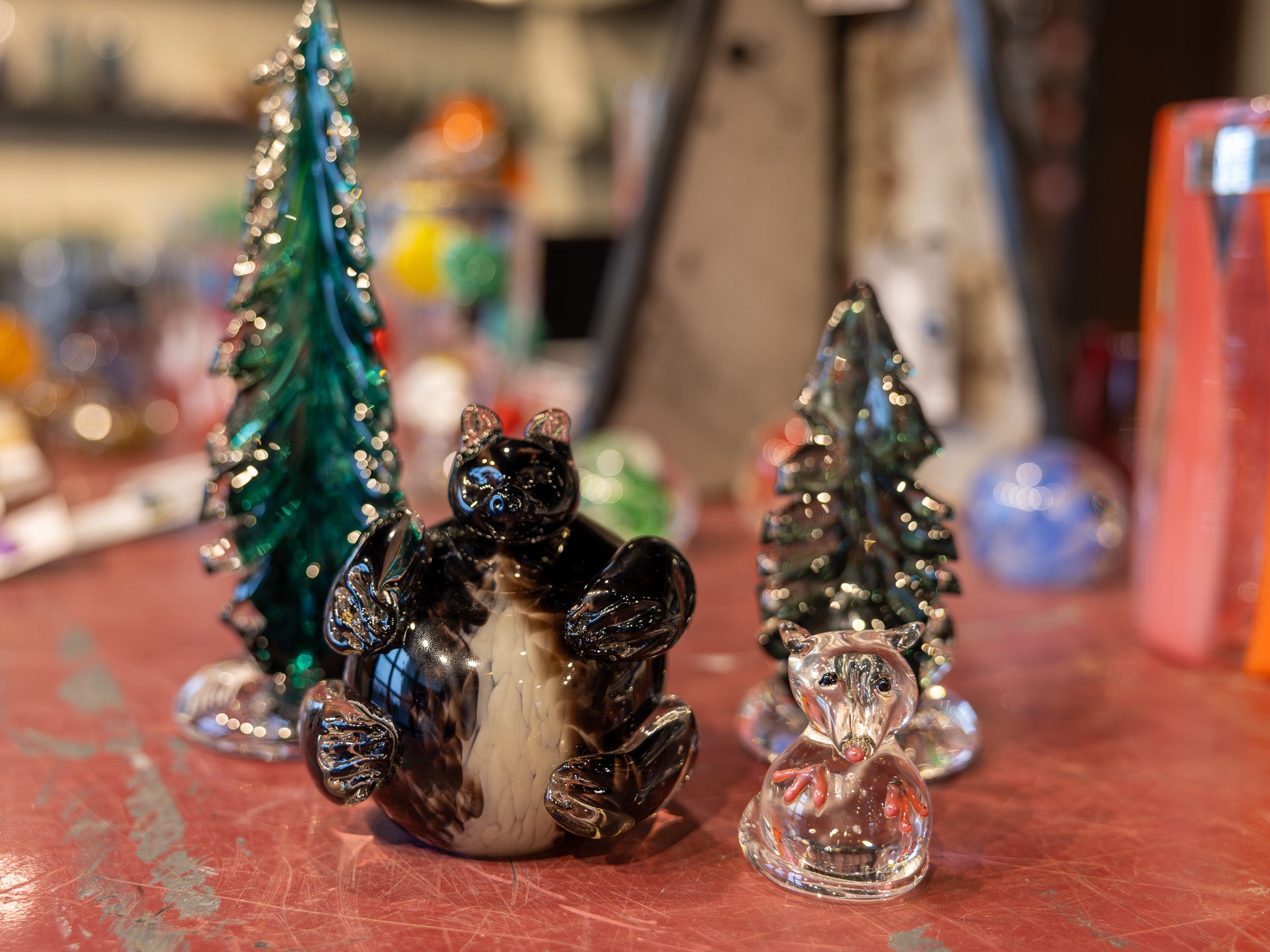 Decorative glass figurines on a table with a blurred background