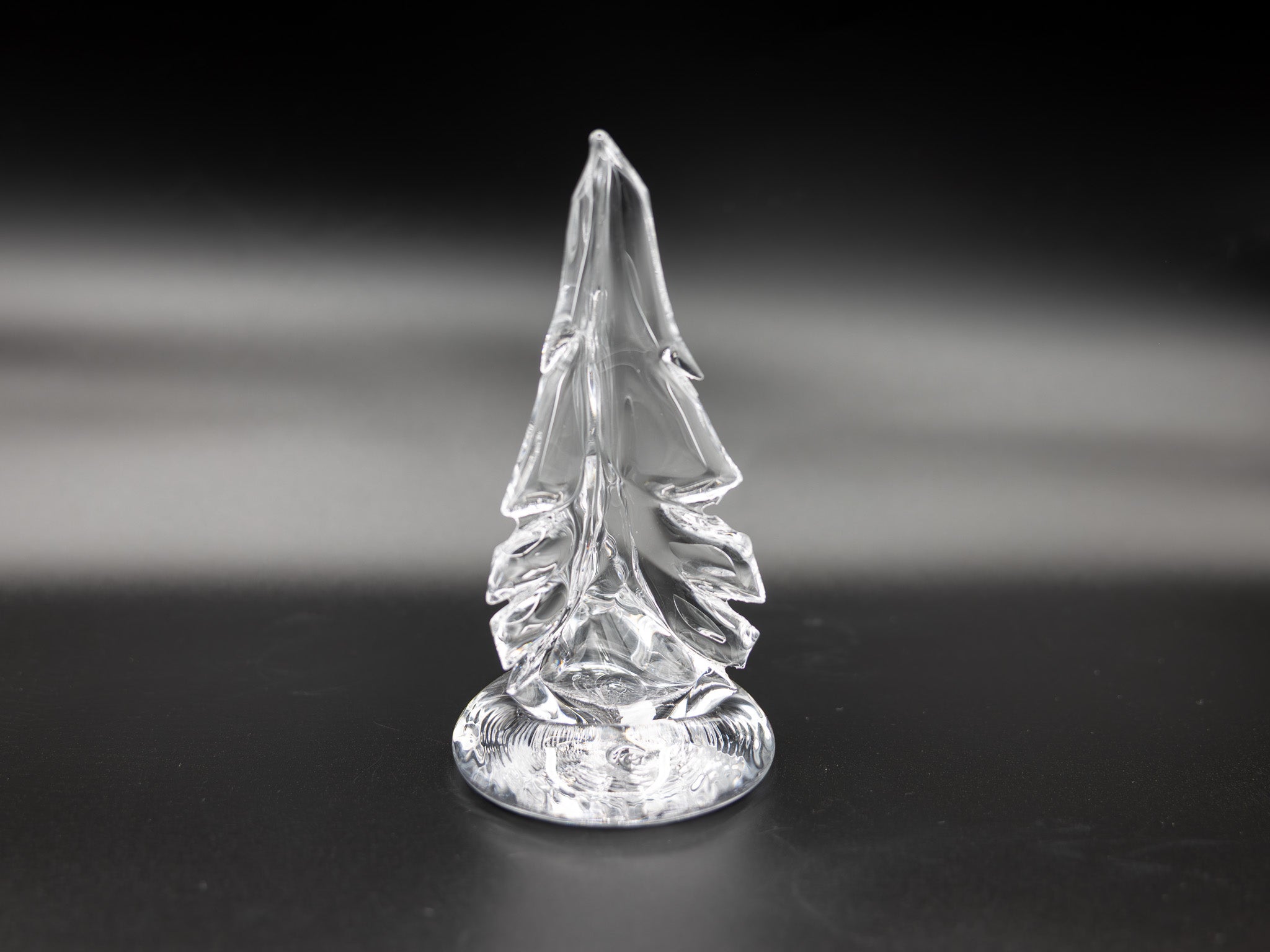 Small clear glass tree on dark background