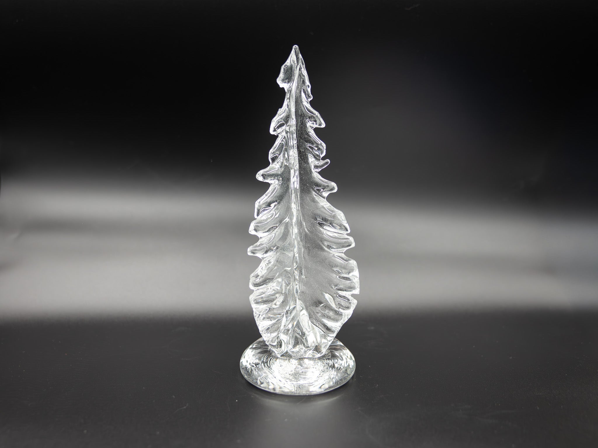 Large clear glass tree on a dark background