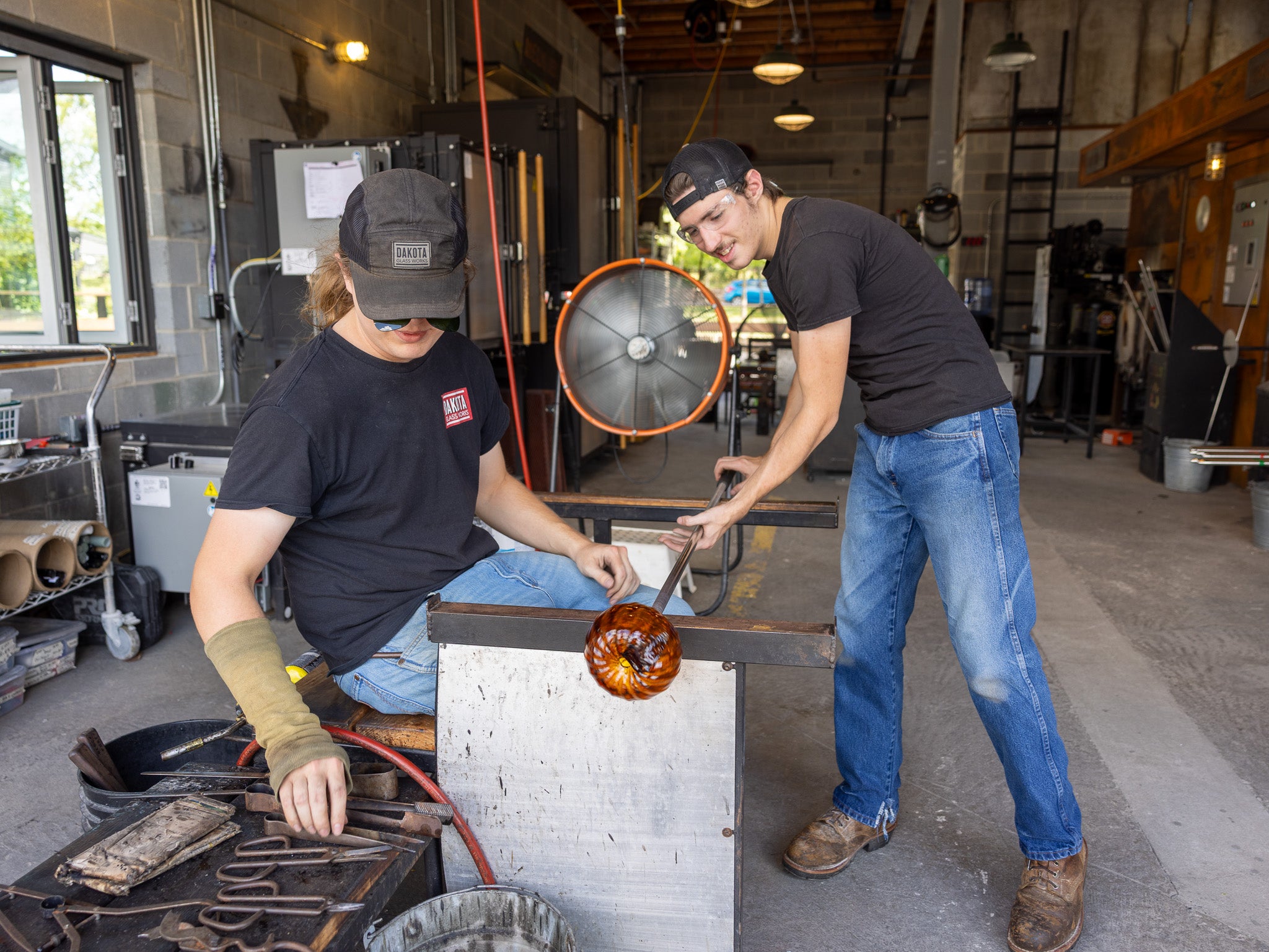 Charles and Jacob making a glass pumpkin