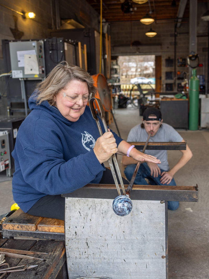A guest enjoying their time making an ornament