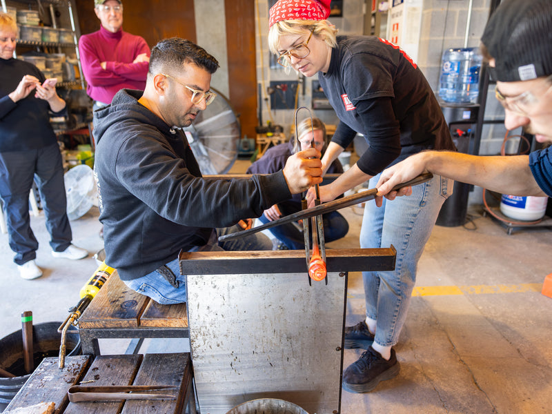 Lucy and Jacob assisting a family make their own cups