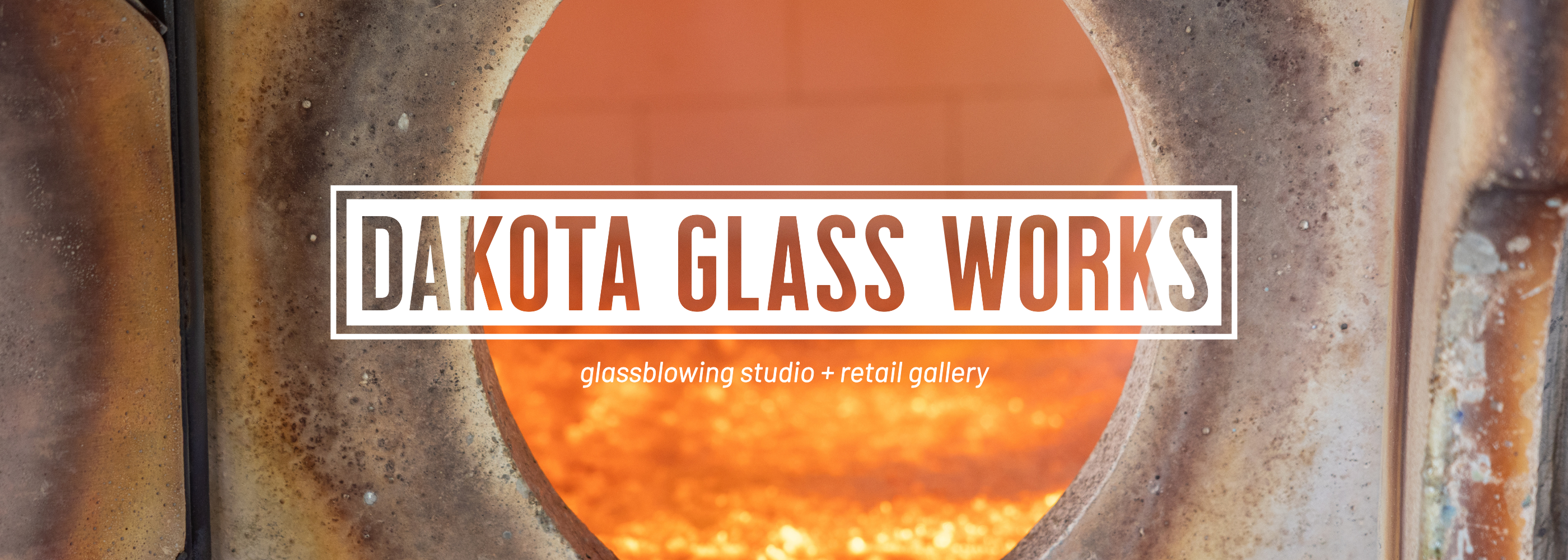 Dakota Glass Works sign with glassblowing studio and retail gallery text on a textured background.