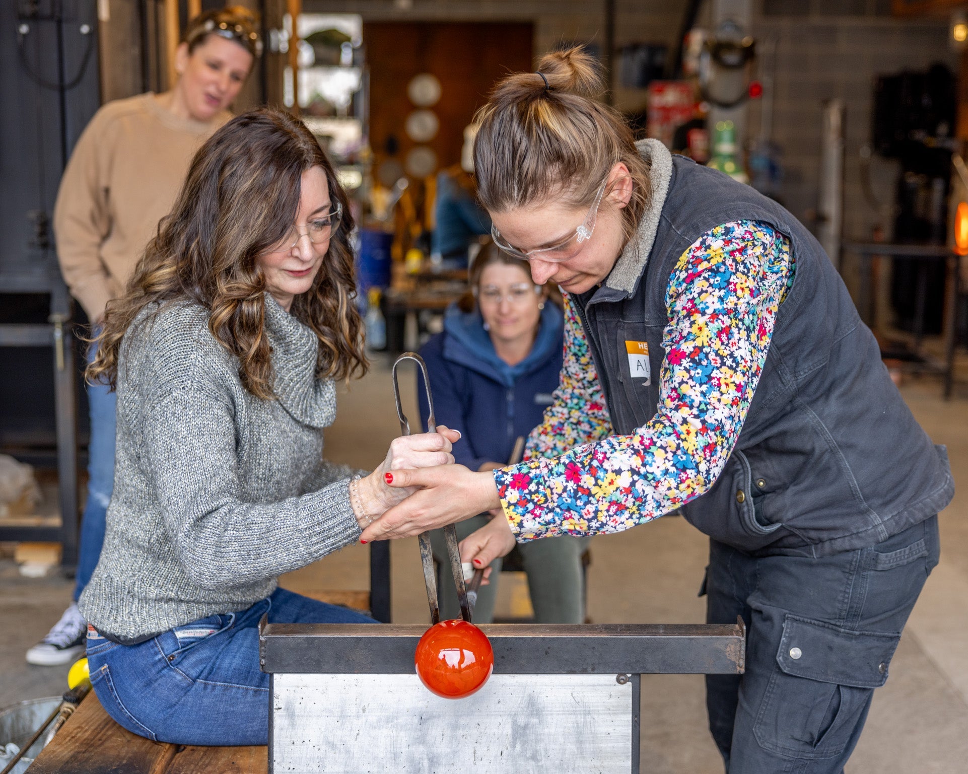 a group of people enjoying their ornament workshops assisted by alex