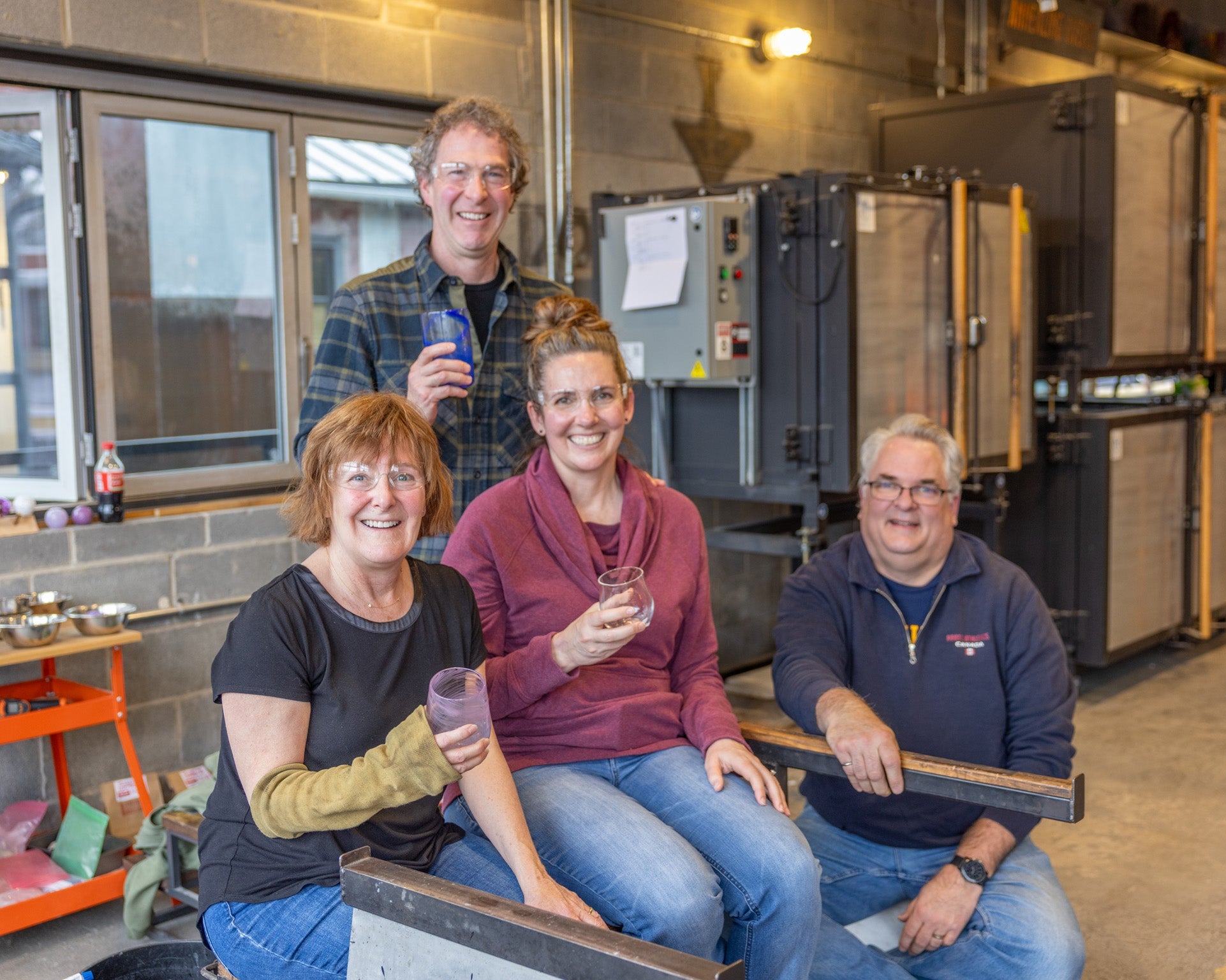 Four people sitting together in a workshop setting.